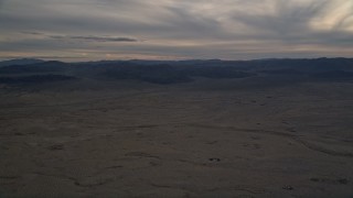 AX0012_054 - 5K aerial stock footage of a desert plain at sunset, Mojave Desert, California