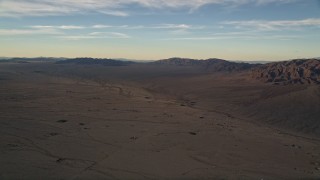 AX0012_056 - 5K stock footage aerial video of desert plain and mountains at sunset, Mojave Desert, California