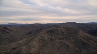 AX0012_057 - 5K aerial stock footage fly by desert mountains, Little San Bernardino Mountains, Mojave Desert, sunset