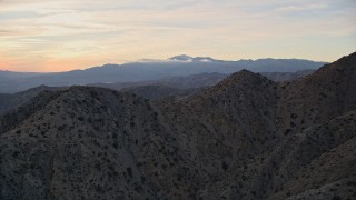 AX0012_062 - 5K aerial stock footage fly over desert mountains, Mojave Desert, California, sunset