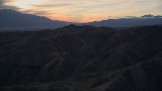 AX0012_064 - 5K aerial stock footage of the desert mountains, Mojave Desert, California, sunset
