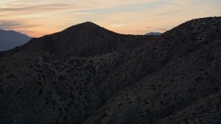 AX0012_067 - 5K aerial stock footage of approaching a desert mountain, Mojave Desert, California