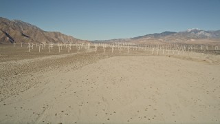 AX0013_002 - 5K aerial stock footage fly by windmills in the desert, San Gorgonio Pass Wind Farm, California