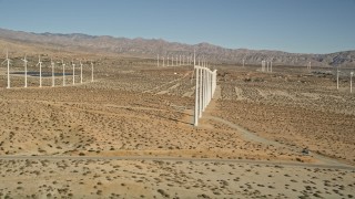 AX0013_013 - 5K aerial stock footage fly by windmills in the desert, San Gorgonio Pass Wind Farm, California
