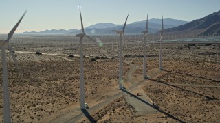 AX0013_017E - 5K aerial stock footage fly by rows of windmills, San Gorgonio Pass Wind Farm, California