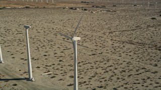 AX0013_022 - 5K aerial stock footage of orbiting a windmill, San Gorgonio Pass Wind Farm, California