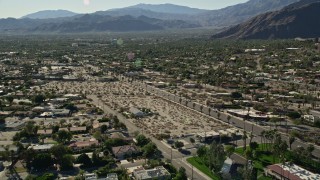 AX0013_033E - 5K aerial stock footage fly over apartment buildings toward residential road, Palm Springs, California