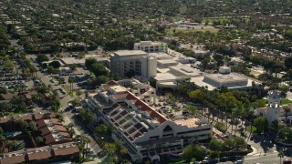 AX0013_035E - 5K aerial stock footage of approaching and orbiting a medical center, West Palm Springs, California