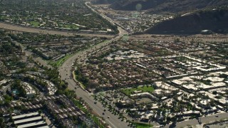 AX0013_042 - 5K aerial stock footage of a street winding through neighborhoods, South Palm Springs, California