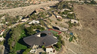 AX0013_051E - 5K aerial stock footage of orbiting a hilltop mansion, West Palm Springs, California