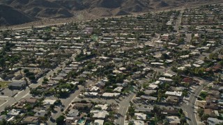 AX0013_057E - 5K aerial stock footage fly over residential neighborhood, Cathedral City, California