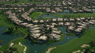 AX0013_062 - 5K aerial stock footage approach upscale homes on the water in Rancho Mirage, California