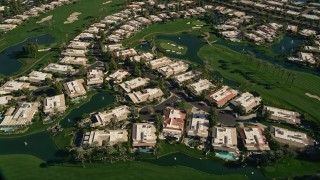 AX0013_063 - 5K aerial stock footage of upscale homes on a golf course, Rancho Mirage, California