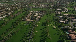 AX0013_064 - 5K aerial stock footage of upscale homes among a gof course, Rancho Mirage, California
