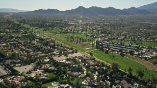 AX0013_067E - 5K aerial stock footage fly over residential neighborhood  toward a golf course, Rancho Mirage, California