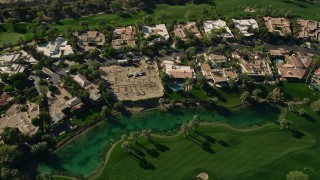 AX0013_076 - 5K aerial stock footage video of upscale home along a golf course, Indian Wells, California