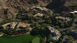 AX0013_080 - 5K aerial stock footage of mansions at the base of a mountain, Indian Wells, California