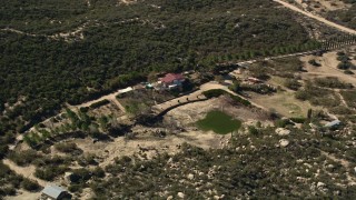 AX0014_025 - 5K aerial stock footage of flying by a rural home, Mountain Center, California