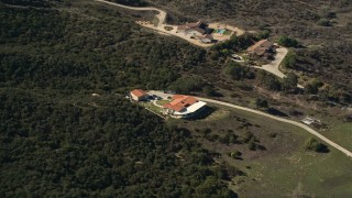 AX0014_037 - 5K aerial stock footage of a home surrounded by trees, Temecula, California