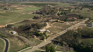 AX0014_057 - 5K aerial stock footage fly over rural homes, Temecula, California