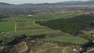 AX0014_067 - 5K aerial stock footage flyby farmland and homes, Temecula, California