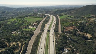 AX0015_011 - 5K aerial stock footage of following interstate with light traffic through the country, Fallbrook, California