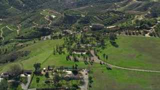 AX0015_012 - 5K aerial stock footage of hilltop homes among farmland, Fallbrook, California