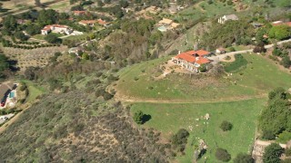 AX0015_023 - 5K aerial stock footage of orbiting a house on a hilltop, Fallbrook, California