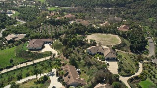 AX0015_025 - 5K aerial stock footage fly by large homes in the hills, Fallbrook, California