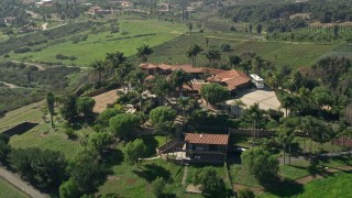AX0015_028E - 5K aerial stock footage approach a large house atop a hill, Fallbrook, California