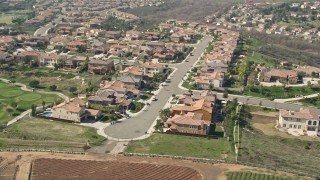 AX0015_040 - 5K aerial stock footage of residential neighborhood near farmland, Oceanside, California