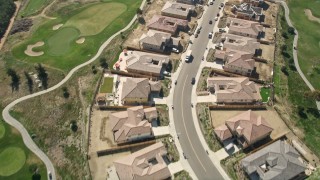 AX0015_042 - 5K aerial stock footage of residential neighborhood and new construction near golf course, Oceanside, California