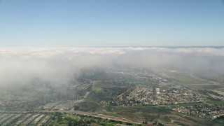 AX0015_048 - 5K aerial stock footage of clouds over a suburban community, Oceanside, California