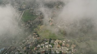 AX0015_052 - 5K aerial stock footage of a bird's eye of residential neighborhoods through clouds, Oceanside, California