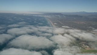 AX0016_021 - 5K aerial stock footage fly over clouds breaking up along the coast, Camp Pendleton, California