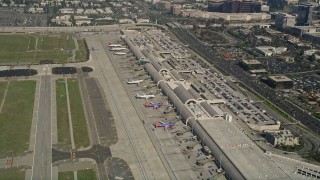 AX0016_083 - 5K aerial stock footage of passenger jets at terminals, John Wayne Airport, Orange County, California