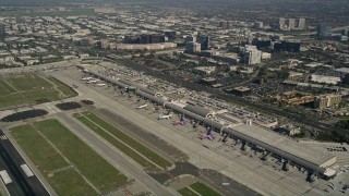 AX0016_084 - 5K aerial stock footage of passenger jets and terminals at John Wayne Airport, Orange County, California
