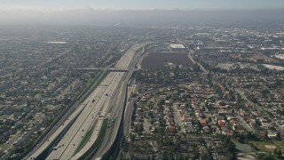 AX0016_088 - 5K stock footage aerial video tilt from a bird's eye view of Interstate 405 and reveal the Highway 73 interchange, Costa Mesa, California