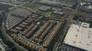 AX0016_090 - 5K aerial stock footage of apartment buildings and tract homes beside a US Post Office facility, Costa Mesa, California