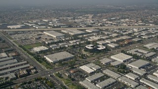AX0016_091 - 5K aerial stock footage fly over office buildings to approach the Santa Ana River, Santa Ana, California