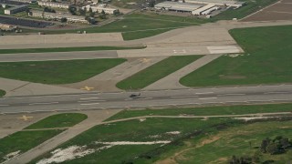 AX0016_096 - 5K aerial stock footage of tracking a helicopter lifting off from Los Alamitos Army Airfield, California