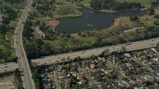 AX0016_103E - 5K stock footage aerial video of track light traffic on I-605 by Long Beach Town Center and El Dorado East Regional Park, Long Beach, California