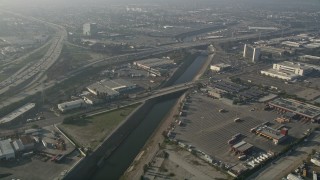 AX0017_025E - 5K aerial stock footage of following the Los Angeles River near Interstate 110; Carson, California