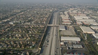 AX0017_032 - 5K aerial stock footage of Interstate 110 along residential and industrial area, Gardena, California
