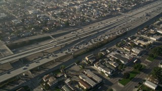 AX0017_034 - 5K aerial stock footage of following Interstate 110 with heavy traffic through neighborhoods, Westmont, California