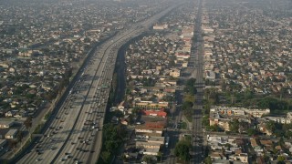 AX0017_035 - 5K aerial stock footage of following Broadway and Interstate 110 past residential neighborhoods, South Central Los Angeles