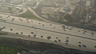 AX0017_037E - 5K aerial stock footage of cars on Interstate 110, South Central Los Angeles