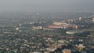 AX0017_040E - 5K aerial stock footage approach Los Angeles Memorial Coliseum, California