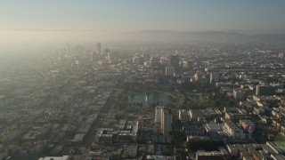 AX0017_074E - 5K aerial stock footage fly over MacArthur Park toward Koreatown, Central Los Angeles, California