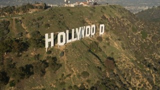 AX0017_090 - 5K aerial stock footage of city sprawl and reveal Hollywood Sign, Hollywood, California